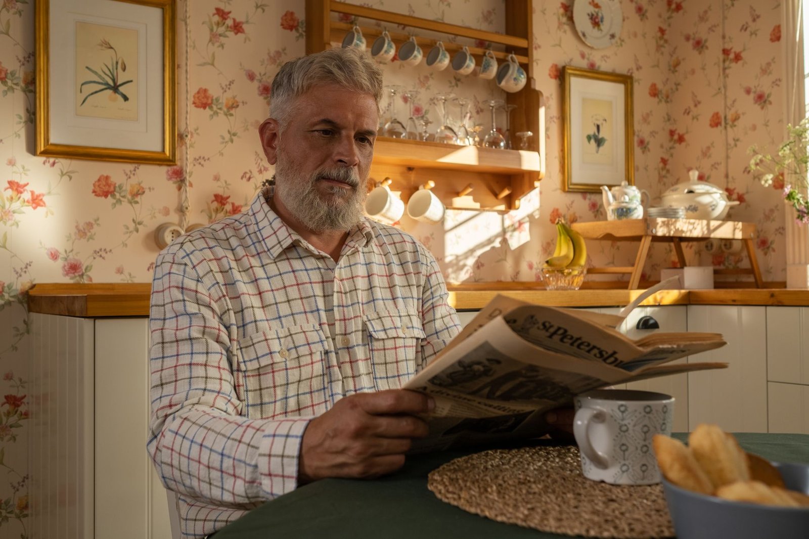 Older veteran at his kitchen table reading a VA overpayment and debt waiver notice