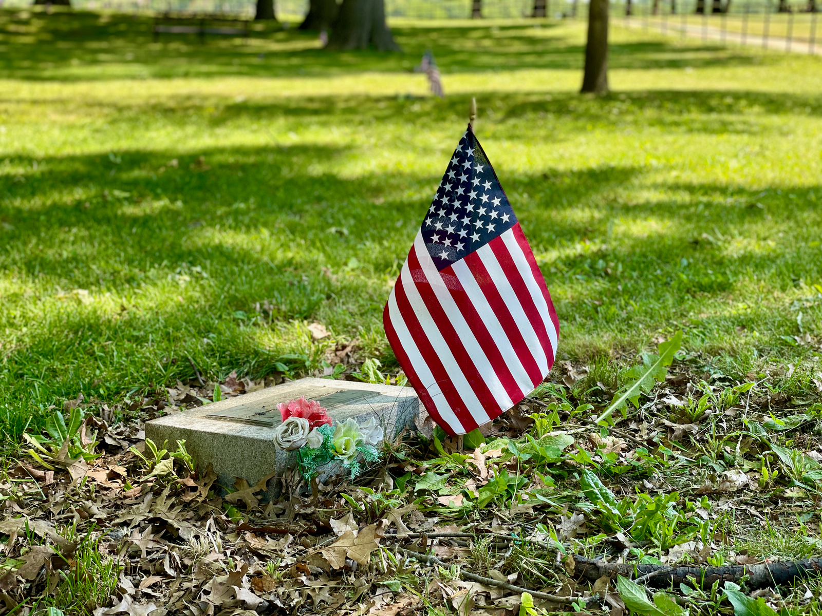 A folded American flag beside a framed service photo, representing a family pursuing VA accrued benefits after a veteran's death