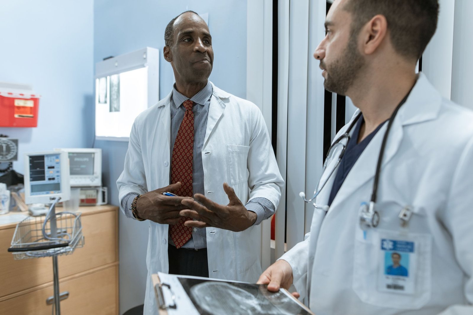 An older veteran discussing VA mesothelioma treatment options with a physician in a clinic