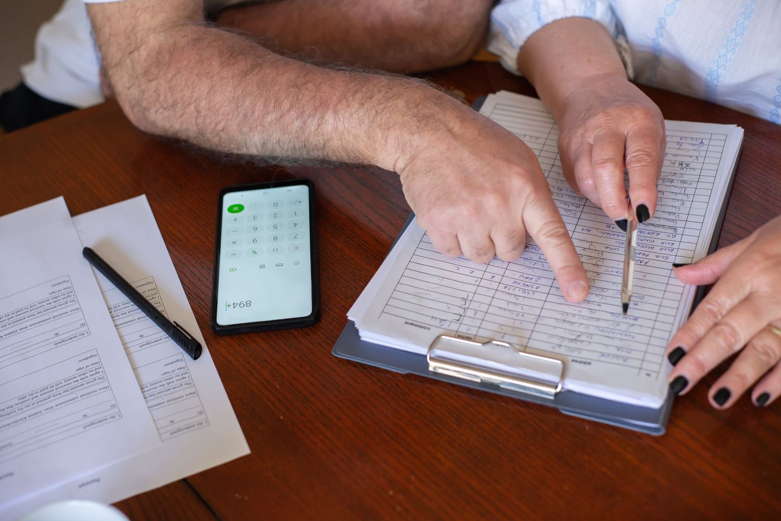 Veteran and spouse calmly reviewing VA emergency care coverage paperwork at home