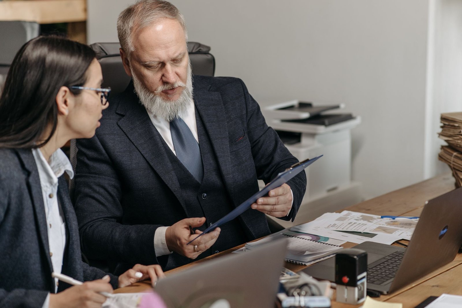 Veteran reviewing a VA debt waiver request with a benefits counselor across a desk