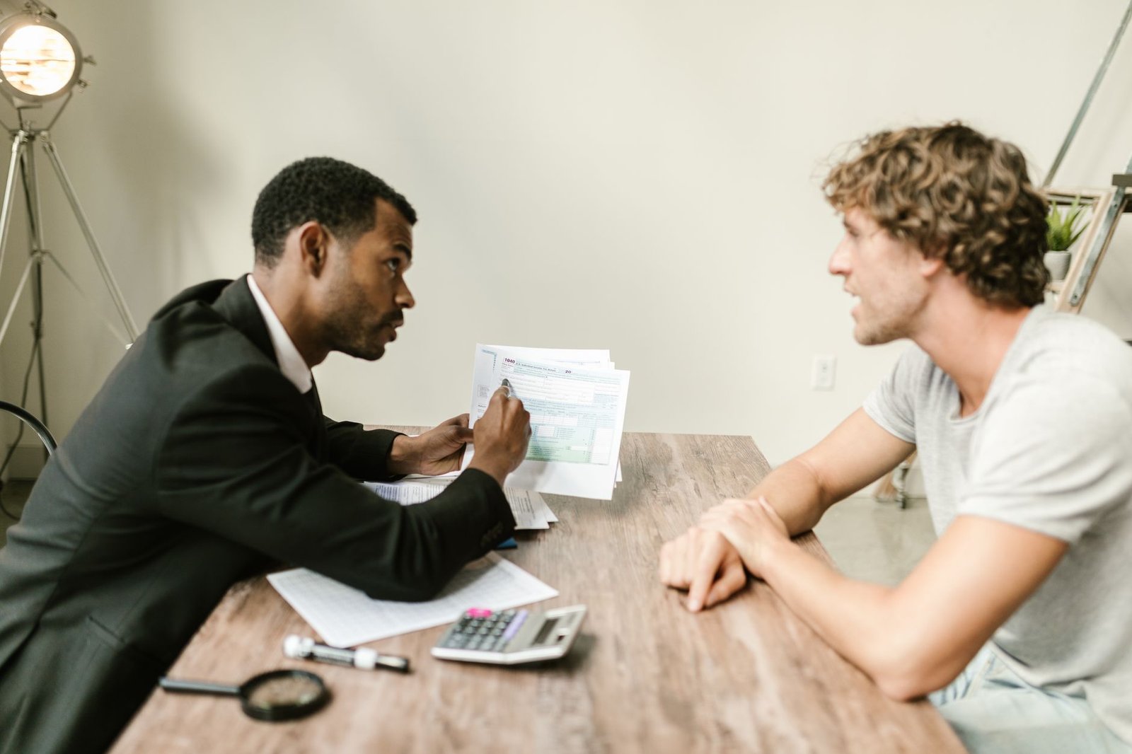 Veteran and advisor reviewing SSDI and VA disability for mesothelioma paperwork together at a desk