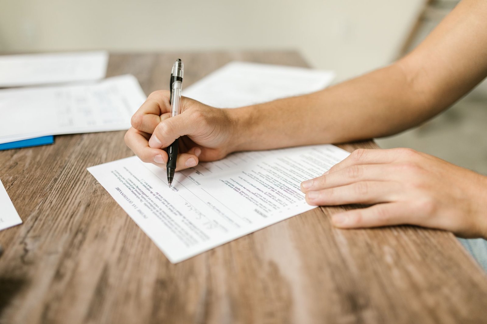 Hands organizing paperwork for an asbestosis versus mesothelioma VA disability claim