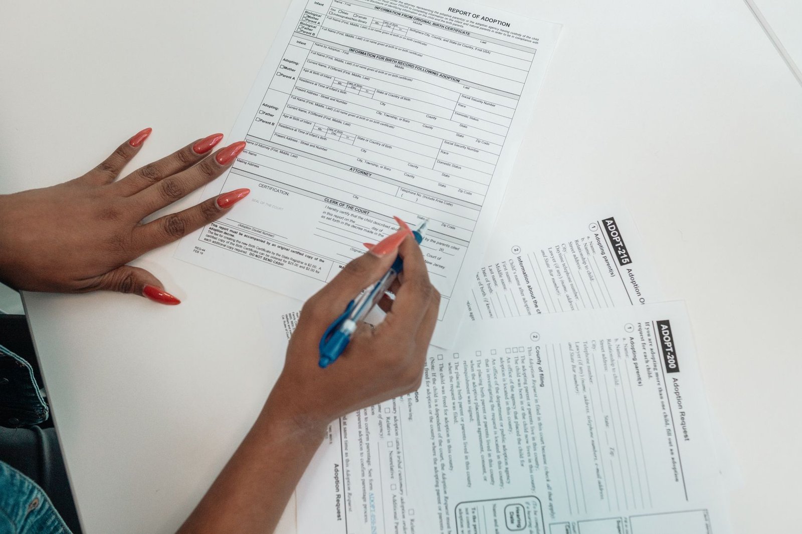 Hands completing VA forms, part of the process of adding dependents to VA disability benefits