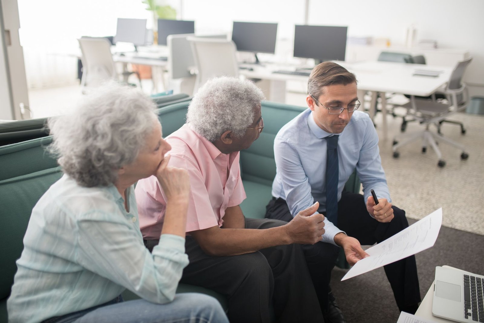 Veteran reviewing a VA health care application with a benefits counselor across a desk