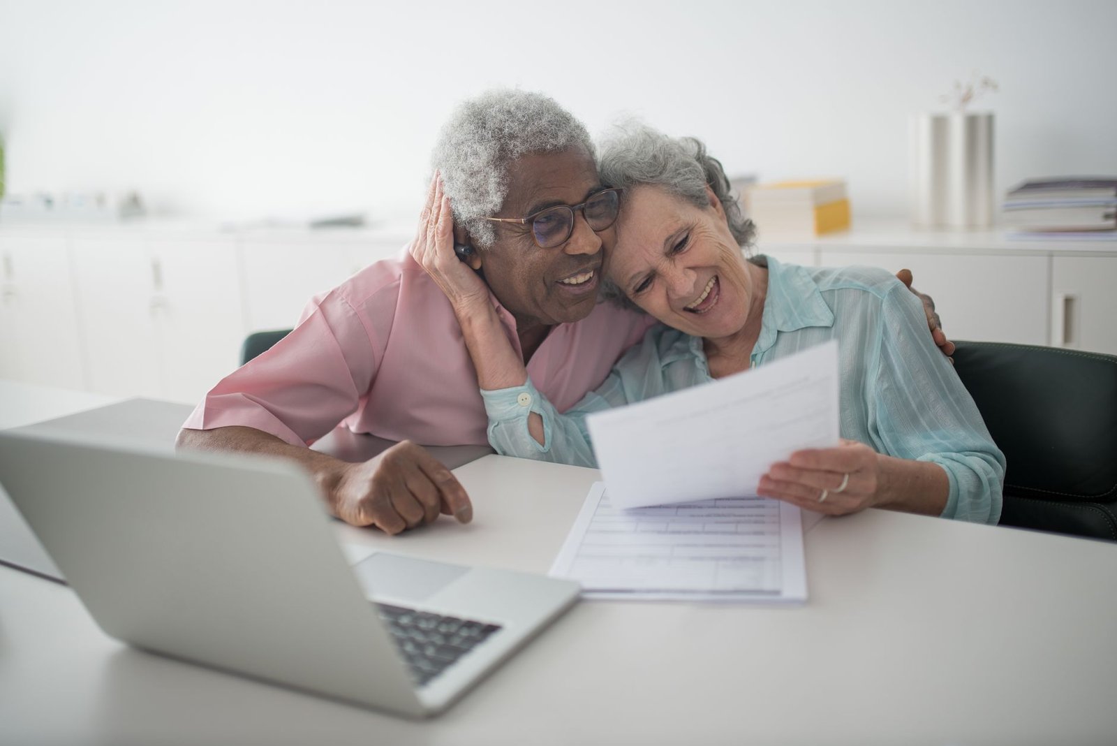 Veteran and spouse reviewing VA home modification grants paperwork at home