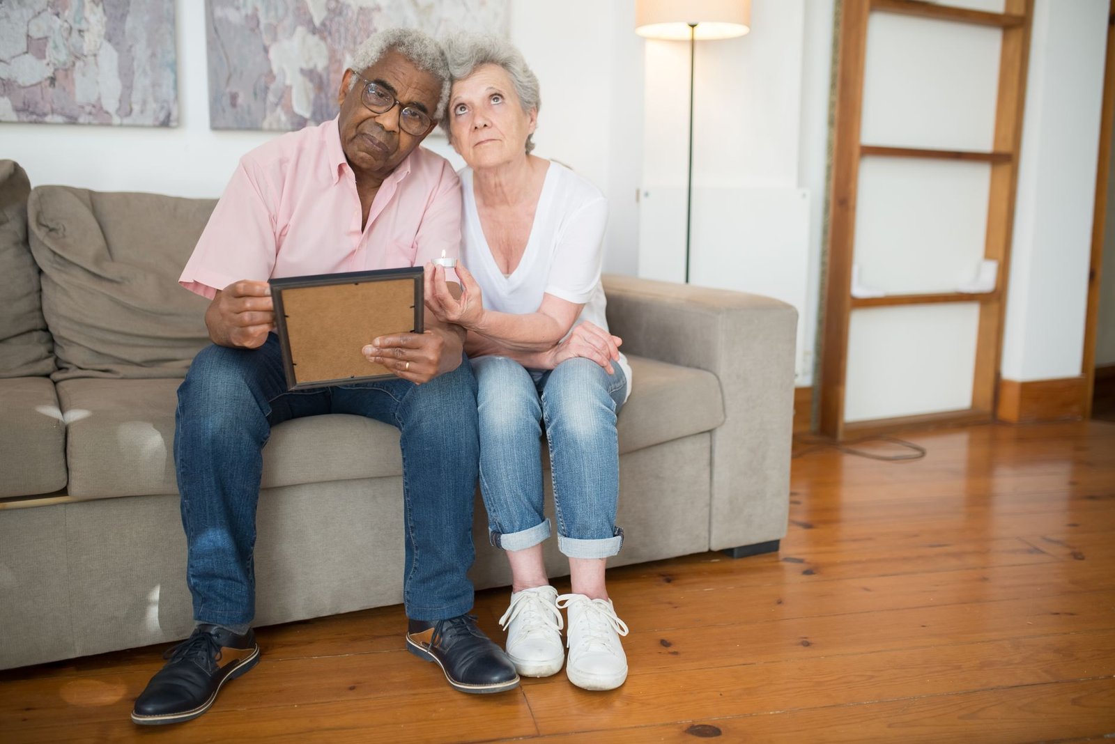 Veteran and spouse at home beside an American flag after discussing a VA disability rating increase