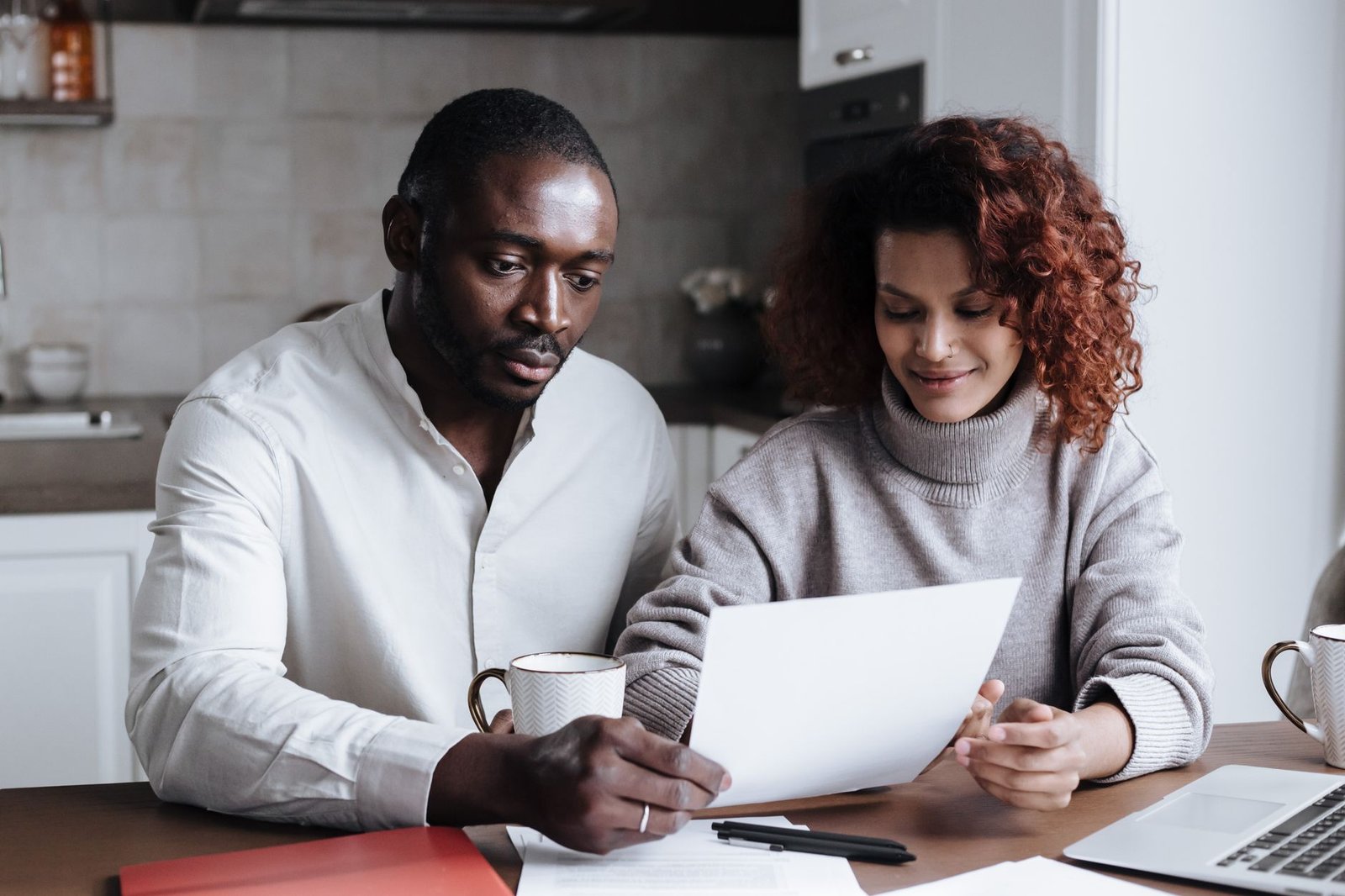 An older veteran reviewing asbestos trust fund and VA benefits claim forms at home